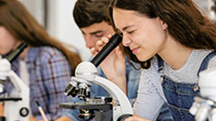 Student looking through a microscope