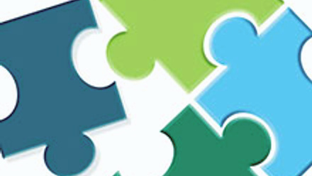 Illustration of four multi-coloured puzzle pieces interlocking.
